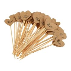 heart shaped wooden picks with the words love and hearts on them are arranged in a row