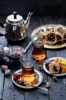 an assortment of teas and pastries on a wooden table