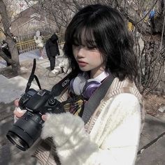 a woman holding a camera in her hands