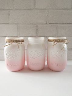 three mason jars with pink and white ombrellas