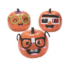 three pumpkins with funny faces and glasses on them