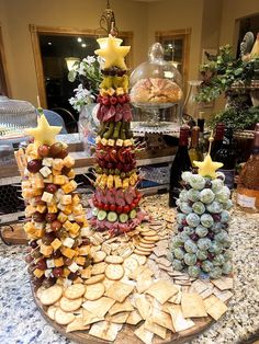 a table topped with lots of different types of food on top of a wooden platter