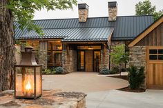 a stone house with a large lantern in front of it