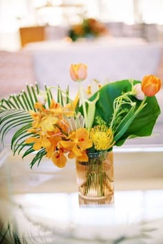 an arrangement of flowers in a vase on a table