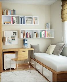 a bedroom with a bed, desk and bookshelves on the wall above it