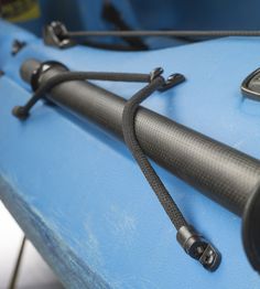 the front end of a blue kayak with black handles