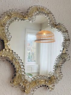 a heart shaped mirror hanging on the wall