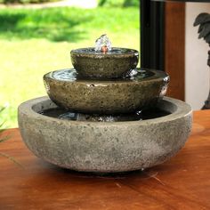 three stone bowls are stacked on top of each other with water running down the sides