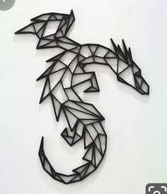 a paper cut out of a dragon on a white wall