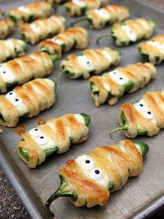 some food is on a pan and ready to be cooked in the oven with eyes drawn on them