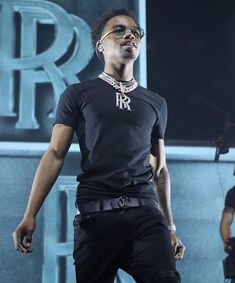 a man standing on top of a stage wearing sunglasses