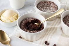 three bowls filled with chocolate pudding and ice cream on top of a white table cloth