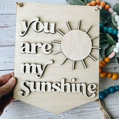 you are my sunshine cutout on wood with beads and greenery around the edges