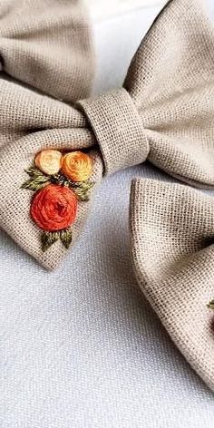 a close up of a bow tie with flowers on it's lapel cover