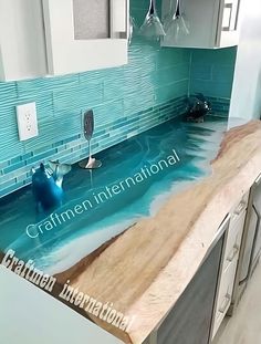 a kitchen counter with blue tiles on it and an ocean scene painted on the counter top