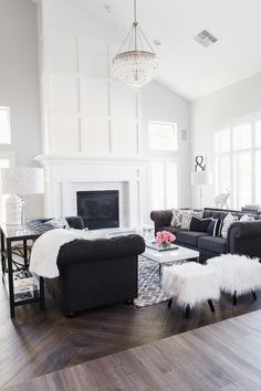 a living room filled with furniture and a fire place in the middle of a room