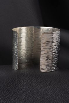 Our Textured Silver Cuff Bracelet is handmade by metal craft artisans in Western India using brass with a silver finish. This contemporary cuff showcases India's rich tradition of metal craft in a modern, textured design. Our fair trade bracelets are made with high quality materials and come in a range of contemporary designs. Silver Wrap Bracelet, Turquoise Silver Bracelet, Feather Bracelet, Cuff Bracelets Handmade, Metal Craft, Silver Feather, Textured Design, Silver Cuff Bracelet, Silver Cuff