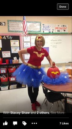 a woman dressed up as wonder from the tv show supergirl posing in her classroom