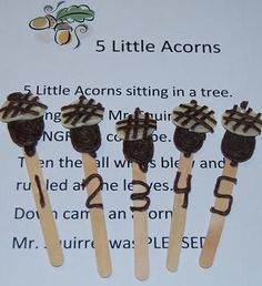 five little acorns sitting in a row on top of each other with chocolate icing