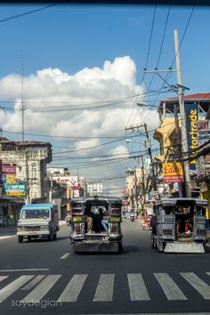 the cars are driving down the busy city street