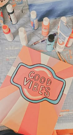 an open book with the words good vibes written on it next to other crafting supplies