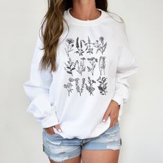 🌻Wildflower Sweatshirt, Botanical Flower sweatshirt, Vintage Graphic Sweatshirt, Wildflower Shirt, Flower Shirt, Botanical Flower Hoodie Unisex Crew Neck Sweatshirt | Gildan 18000 This well-loved Unisex Crew Neck Sweatshirt is the perfect addition to any collection! The air-jet spun yarn and quarter-turned fabric helps eliminate creases and piling,  while the mix of cotton and polyester creates a soft and comfortable feel. 50% cotton, 50% polyester. Unisex Heavy Blend Hoodie | Gildan 18500 With Wildflower Sweatshirt, Daisy Sweatshirt, Wildflower Shirt, Flower Hoodie, Fall Shirts Women, Flower Sweatshirt, Pumpkin Sweatshirts, Coffee Sweatshirt, Holiday Sweatshirt