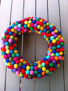 a colorful wreath made out of pom - poms