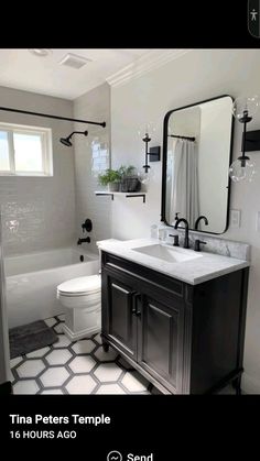 a bathroom with a sink, toilet and bathtub in black and white tile on the floor