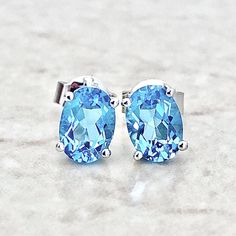 14K Oval Blue Topaz Stud Earrings - Solid 14K White Gold Blue Topaz Earrings - November December Birthstone Earrings - Birthday Gift For Her Beautiful 14 karat white gold studs earrings featuring two natural 7x5 mm oval Swiss blue topaz, an alternative birthstone for December.  Topaz itself -in any of its color- is also the birthstone for November.  The gemstones weigh approximately 1.55 carat.  Closure: Push Backs  Birthstone: November/December. Condition: Brand New. - 14-day return policy, no Blue Oval Topaz Earrings, Blue Topaz Oval Earrings, Oval Topaz Earrings For Gift, Oval Topaz Earrings As Gift, Oval Topaz Earrings For Anniversary, Gold Studs Earrings, North Miami Beach, White Gold Earrings Studs, White Gold Studs