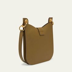 TOM FORD "Tara" crossbody bag in grain leather, faux leather (polyurethane), and brass  Detachable, adjustable shoulder strap Detachable, adjustable crossbody strap Can be worn as a shoulder or crossbody bag  Open top with center T-strap magnetic closure  Interior, one zip pocket  Lining: Polyurethane Approx. 9.8"H x 9.8"W x 0.8"D Item Weight (Lbs.): 1.5 Made in Italy Open Top, T Strap, Crossbody Strap, Magnetic Closure, Tom Ford, Zip Pockets, Crossbody Bag, Grain, Tops Designs