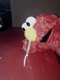 a red stuffed animal sitting on top of a table