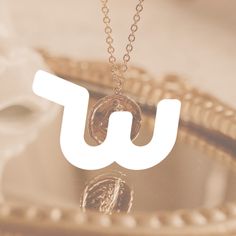 a necklace with the letter u on it