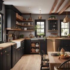 a kitchen with black cabinets and wooden floors