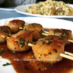 some food is on a white plate with chopsticks