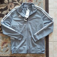 Adidas Climalite Ladies Track Top, Nwt, Size L, Pretty Light Grey Color With Signature Logo And Three Stripes In White, Front Zippered Closure, Two Front Side Zippered Pockets, Moisture Wicking, Stay Dry, Stay Comfortable Climalite Keeps Your Body Dry By Drawing Sweat Away From The Skin, 100% Polyester, Msrp:$65, Please See Pictures For Measurements:) Super Cute:) *Host Pick* Winter Training Outerwear With Three Stripes, Adidas Casual Track Jacket For Training, Casual Adidas Logo Outerwear For Training, Adidas Sportswear For Training, Casual Adidas Training Outerwear, Casual Adidas Outerwear For Training, Adidas Winter Training Track Jacket, Adidas Athleisure Training Outerwear, Adidas Sporty Track Jacket For Training