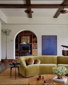 a living room filled with furniture and a piano