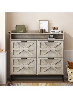 a white dresser with wooden doors and drawers in a room next to a rug on the floor