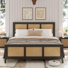 a bed with wicker headboard and foot board next to two lamps on either side of the bed