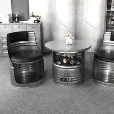 two chairs and a table in a room with grey carpeted flooring on the walls