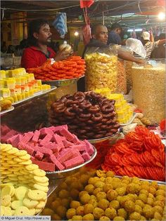 many different types of food on display at a market