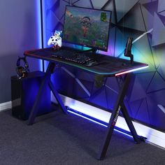 a computer desk with a gaming keyboard and mouse on it in front of a wall