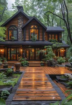 a large wooden house surrounded by trees and greenery in the evening time with lights on