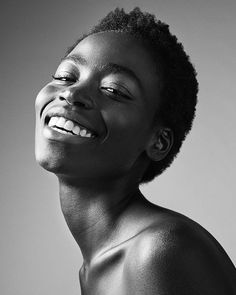 a black and white photo of a woman smiling