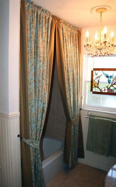 a bath room with a tub and a chandelier