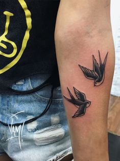 a couple of birds that are on the arm