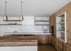 a kitchen with wooden cabinets and white walls