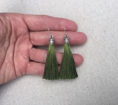 "Chic olive green tassel earrings! They would add a pop of color to any outfit for any occasion. Dress them up or down. They are timeless and versatile. They are lightweight, fun and unique! The tassels measure 2 1/8\" long by 1/4\" wide. They hang from simple silver ear wire hooks. Overall drop length is about 2 1/4\". Metal is allergy free plated silver. These are my latest creation! I have them available in many colors! Find them all under the category tassel earrings in my shop. Thanks for s Green Tassel Drop Earrings As Gift, Green Tassel Earrings For Gift, Olive Green Jewelry, Green Tassel Earrings, Crescent Moon Jewelry, Motivational Jewelry, Silver Statement Earrings, Crescent Moon Earrings, Green Jewelry