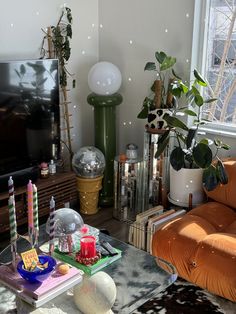 a living room filled with furniture and a flat screen tv sitting on top of a wooden table