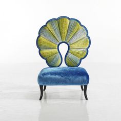 a blue and yellow chair sitting on top of a white floor