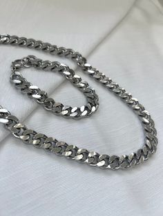 Chunky Curb Chain Necklace & Matching Bracelet set ⛓ Stainless Steel  The perfect everyday wear, non-tarnish (will not change color) & hypoallergenic necklace sold with an adorable matching bracelet! Price of bracelet is included in the necklace length dropdown options.  Details:  * CHOKER always comes w/ extension * Optional 2" extension chain so you can adjust to your preference! (shown as a range in length options) * Matching bracelet comes with either no extension chain or a 1" extension chain:) * Also pictured above is 18" + 2" extension  * All components of necklace are stainless steel and waterproof * About 10mm thick (about 3/8") * Affordable//Quality Find INDIVIDUAL pieces here: Bracelet: https://www.etsy.com/listing/1125281983/silver-bracelets-stainless-steel-curb?variation0=2361 Chunky Silver Bracelet, Hypoallergenic Necklace, Bracelet Matching, Necklace Matching, Bracelet Set Silver, Necklace And Bracelet Set, Curb Chain Necklace, Necklace And Bracelet, Matching Bracelet